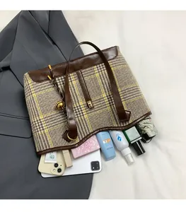 Interior view showing large storage capacity of houndstooth tote with daily essentials