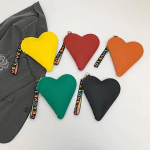 Vibrant heart-shaped crossbody bags in assorted colors with litchi grain faux leather finish