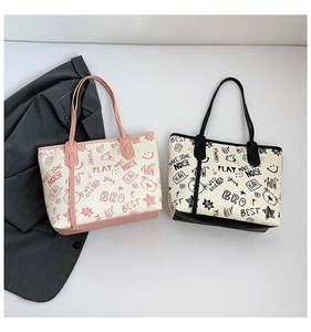 Detail view of graffiti pattern tote bags in pink and black on a white background