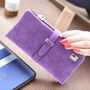 Detail of a purple matte leather long wallet featuring a zipper and metal logo
