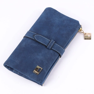 Detail of navy blue suede-like long wallet with white stitching and gold zipper hardware