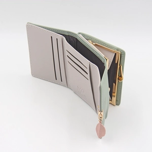 Detail view of tri-fold wallet with multiple card slots and leaf pendant zip