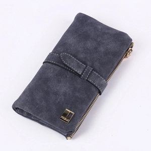 Detail of matte dark blue wallet with white stitching and FRIEND gold logo plate