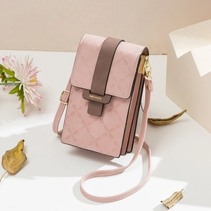 Detailed macro view of pink PU leather phone bag with embossed floral texture and metal buckle