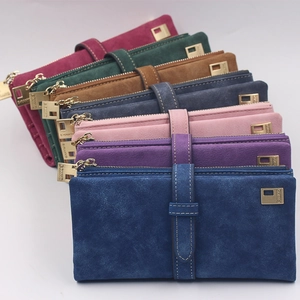 Detailed pile of matte leather long wallets in seven colors with elegant strap closures