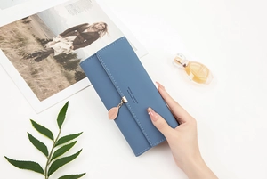 Chic long blue PU leather wallet featuring a rose gold leaf pendant and snap closure