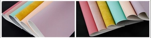 Texture detail of synthetic PU leather in various pastel colors for long wallets