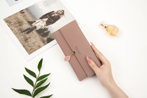 Pink PU leather long wallet detail with leaf pendant and multiple card slots shown
