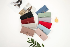 High-angle view of multiple colorful PU leather tri-fold wallets with leaf pendants