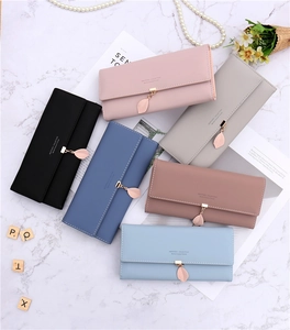 Detailed flat lay of PU leather long wallets in multiple colors with leaf metal charms