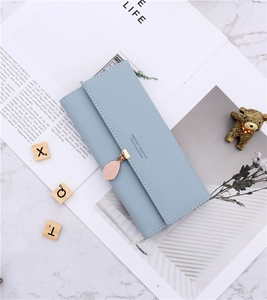 Detailed view of light blue tri-fold long wallet with elegant pink leaf pendant decoration