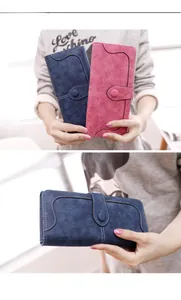 Detail of vintage suede long wallets with wavy stitching and buckle closure