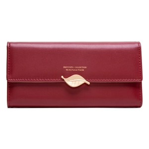 Detail of wine red PU leather wallet featuring a golden leaf pendant and brand logo