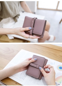 Detail of Morandi purple leather folding wallet with lychee texture and buckle closure