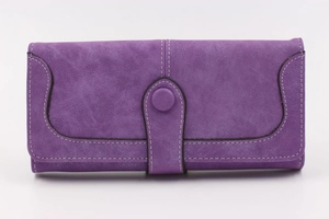 Close-up of purple faux suede wallet with decorative white stitching and snap button