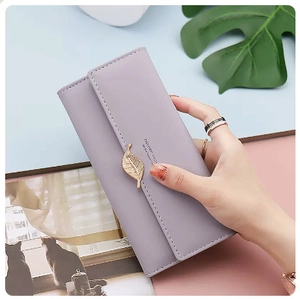 Detail of lavender PU leather long wallet featuring a decorative gold leaf pendant