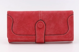 Detail of red vintage long wallet with matte texture and white contrast stitching detail