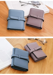 Close-up of litchi texture on blue and gray bifold wallets with contrast stitching