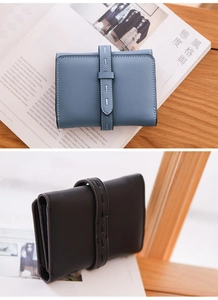 Macro detail of lychee textured leather wallets with contrast stitching on decorative straps
