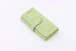 Close-up of light green long wallet featuring snap closure and multi-card slots