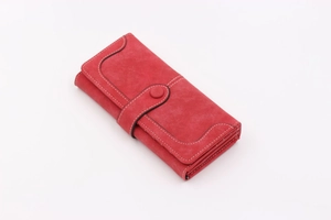 Detail view of red vintage long wallet featuring decorative stitching and snap closure