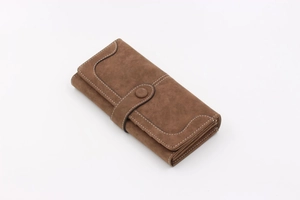 Detail of dark brown matte leather wallet showing contrast stitching and buckle closure