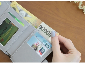 Detail of grey leather trifold wallet showing multiple card slots and clear ID window
