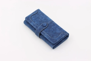 Detail of dark blue vintage long wallet featuring white stitching and layered accordion design