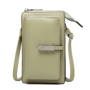 Detail of light green leather phone bag with metal buckle and adjustable strap