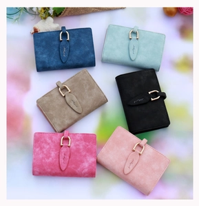 Detailed overhead view of various frosted PU leather wallets with elegant leaf metal buckles
