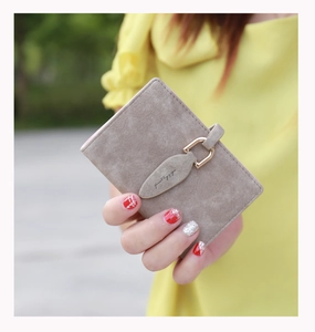 Close-up of a frosted vintage card holder featuring a gold leaf buckle and 'pretty' engraving