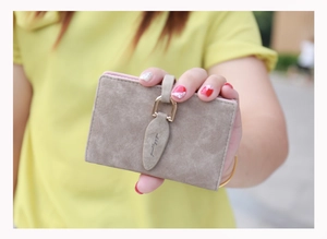 Close-up of vintage frosted card holder with leaf buckle and pink inner lining