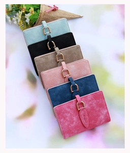 Macro detail of multi-color retro matte wallets with decorative leaf buckle closure