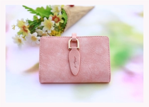 Close-up of pink frosted card wallet with leaf charm and golden buckle closure