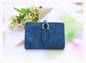 Detail of blue matte leather wallet with golden leaf clasp and prettyzys brand logo