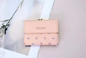 Detailed close-up of pink floral PU leather wallet with elegant gold metal clasp
