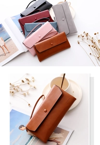 Close-up of matte leather long wallets in various colors with wristlets and button closure