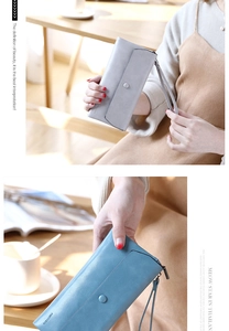 Close-up of matte long wallets in grey and blue with wrist straps and snap closure