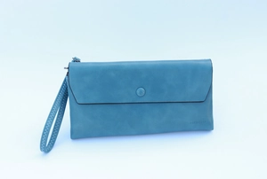 Close-up of blue textured long wallet featuring a round snap button and matching wrist strap