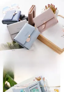 Detailed interior of women's short wallet showing card slots and leaf metal charm