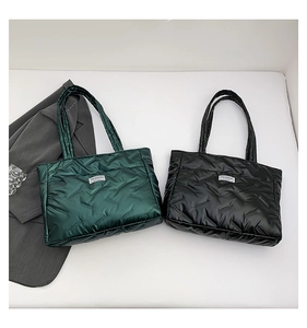 Detailed quilted texture and FASHION label on puffer tote bags in green and black colors