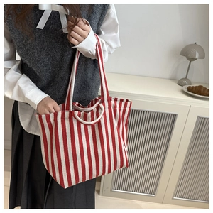 Detail of red and white striped canvas tote bag with spacious interior for daily casual use
