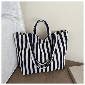 Close-up of blue and white striped canvas tote bag showing soft fabric texture and straps