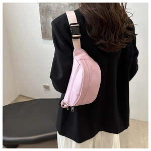 Rear view of a pink minimalist canvas chest bag with adjustable strap and dual zippers