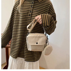 Detail of beige canvas crossbody bag with Dachshund print and matching coin purse
