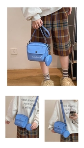 Detailed view of the blue canvas crossbody bag with mini pouch and Dachshund print