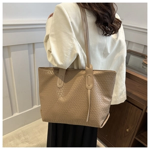 Beige woven texture large tote bag for women showing a stylish minimalist commuter design