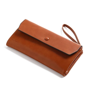 Minimalist caramel brown long leather wallet with hand strap and snap closure design