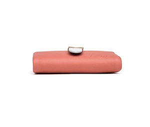 Detail of coral pink leather wallet with blue-grey buckle and subtle matte texture