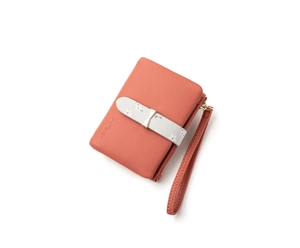 Detail of salmon pink PU leather wallet with floral strap, golden bow, and zip wristlet